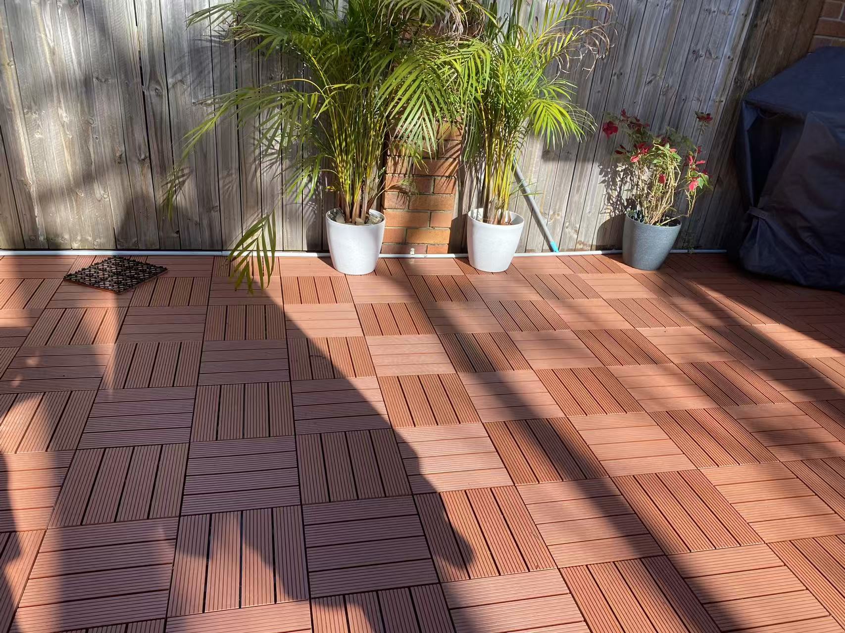 Warm courtyard deck surface beside the home