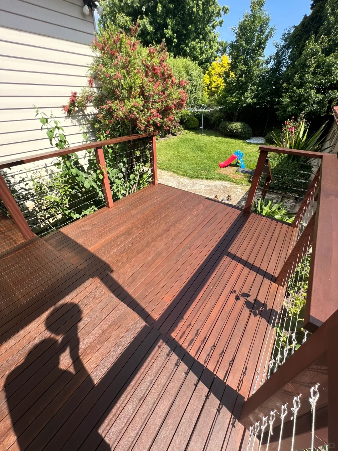 Restored timber deck with oiled boards and handrails