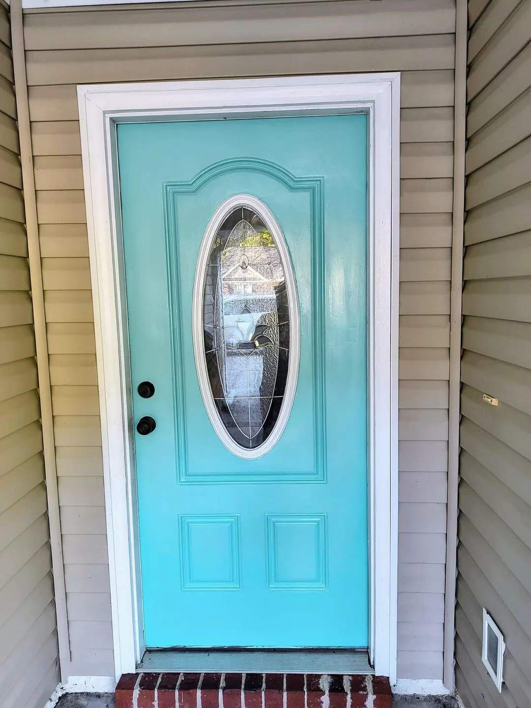 Restored aqua entry door with decorative oval glass