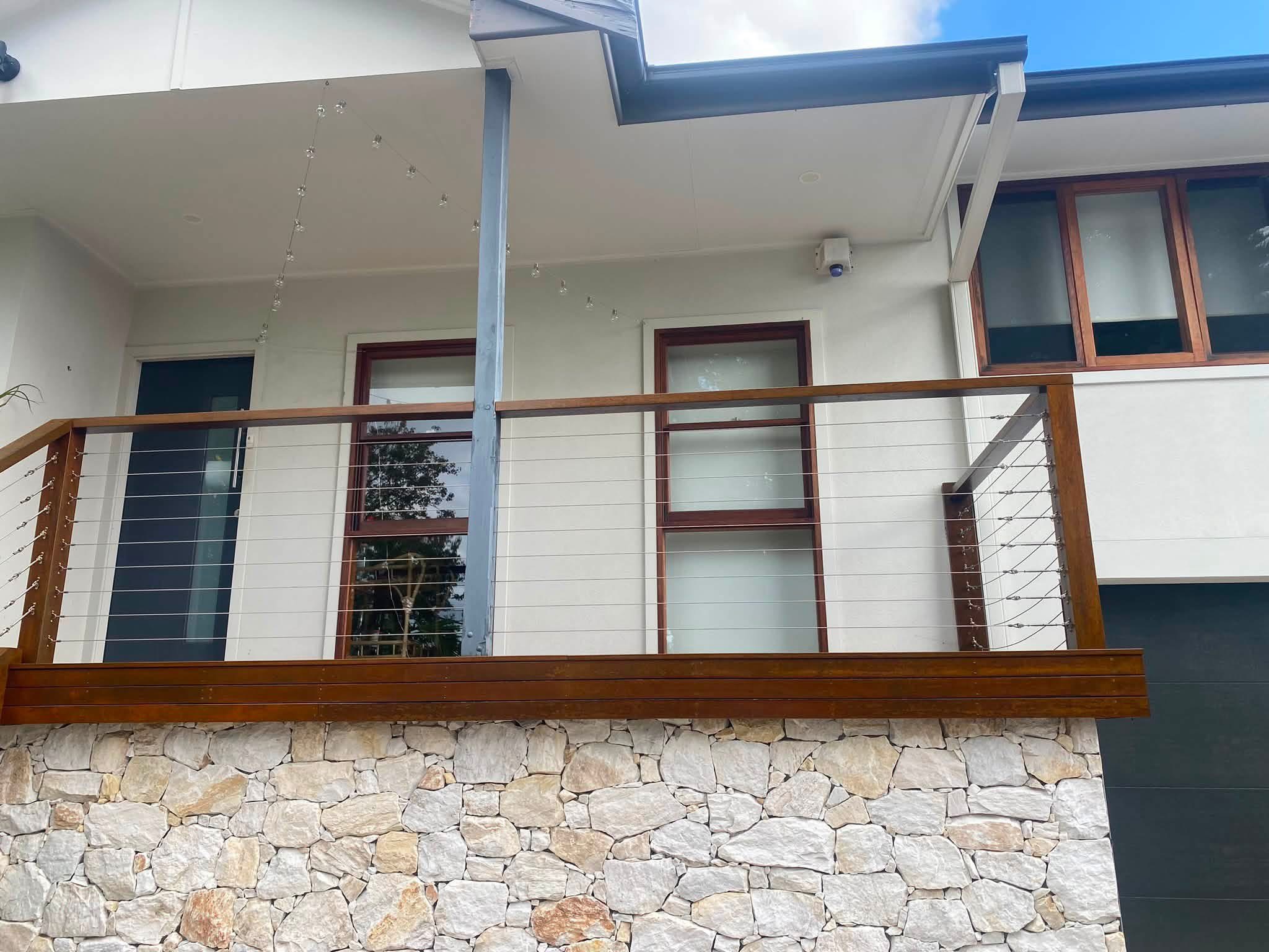 Completed exterior timber windows above a residential balcony